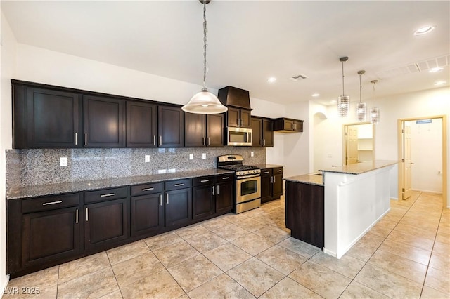 kitchen featuring hanging light fixtures, visible vents, tasteful backsplash, and appliances with stainless steel finishes