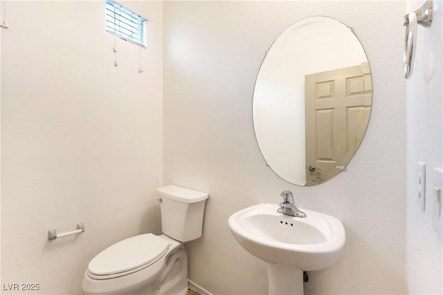 bathroom featuring toilet and a sink