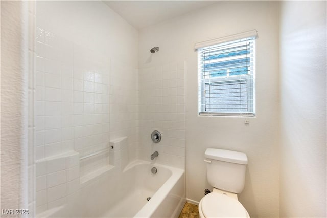 bathroom featuring shower / bath combination and toilet