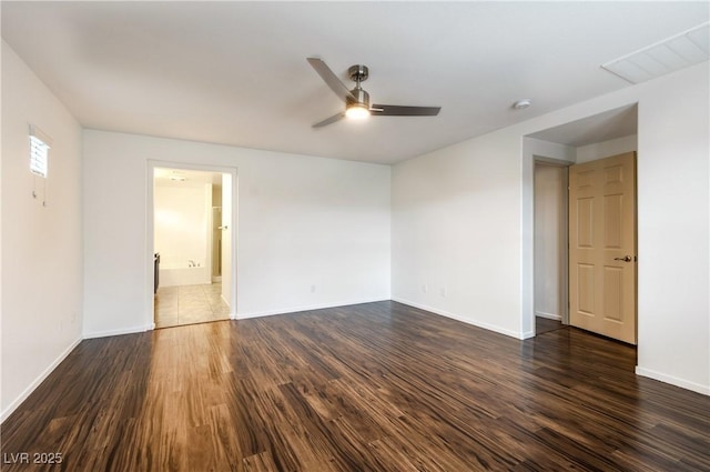 empty room featuring ceiling fan, baseboards, and dark wood-style floors