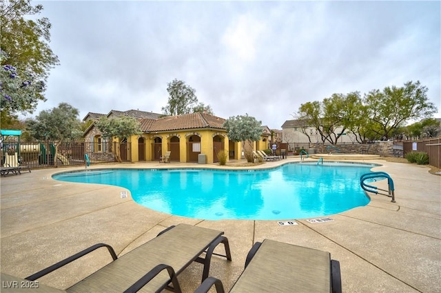 pool featuring a patio area and fence