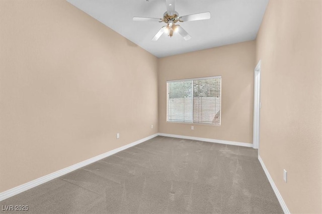 carpeted spare room featuring baseboards and ceiling fan