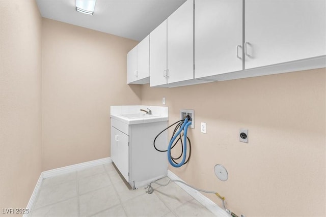 clothes washing area with hookup for a washing machine, baseboards, hookup for an electric dryer, gas dryer hookup, and a sink