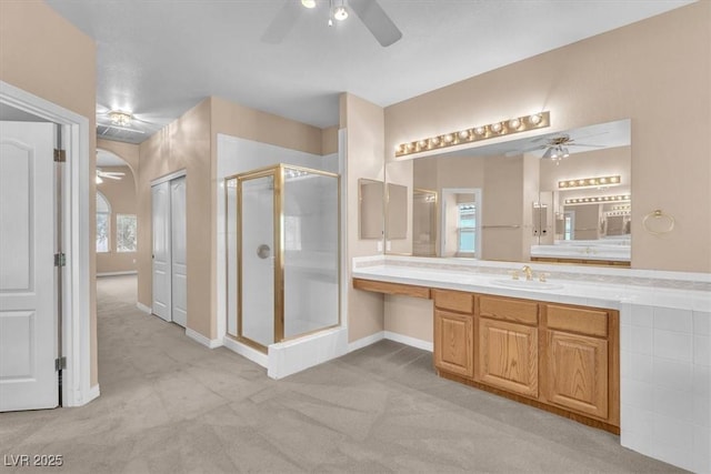 full bathroom featuring vanity, a stall shower, and ceiling fan