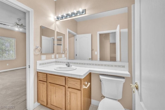 bathroom featuring visible vents, vanity, toilet, and a ceiling fan