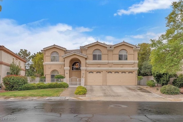 mediterranean / spanish-style house with stucco siding, concrete driveway, an attached garage, and fence