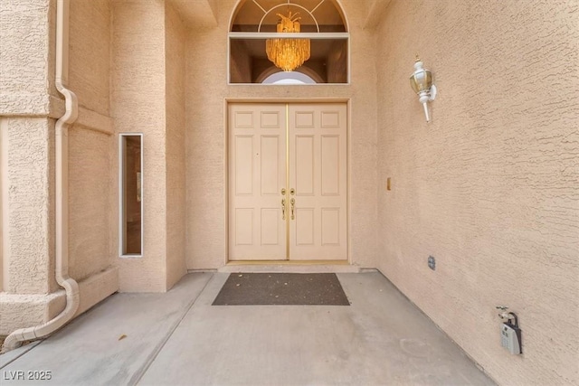 doorway to property with stucco siding