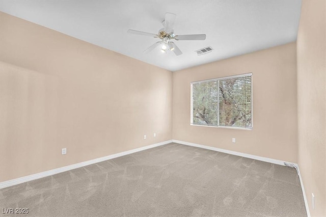 carpeted empty room featuring visible vents, baseboards, and ceiling fan