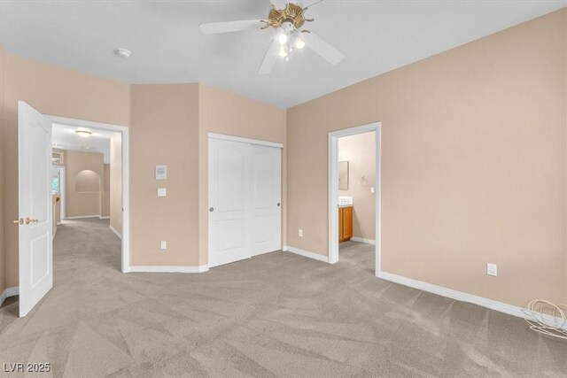 unfurnished bedroom featuring a closet, a ceiling fan, baseboards, and carpet floors