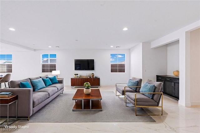 living area featuring recessed lighting, marble finish floor, and baseboards