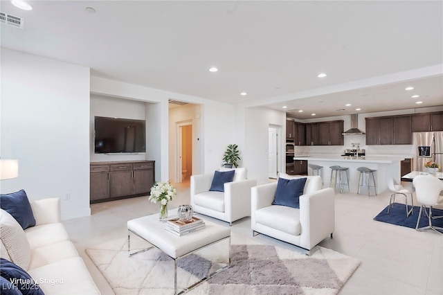 living area featuring recessed lighting, visible vents, and light tile patterned flooring