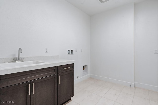 clothes washing area featuring hookup for a washing machine, cabinet space, baseboards, and a sink