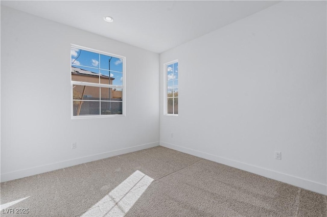 carpeted empty room featuring recessed lighting and baseboards