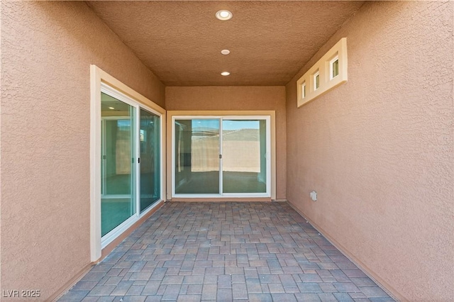 property entrance with stucco siding