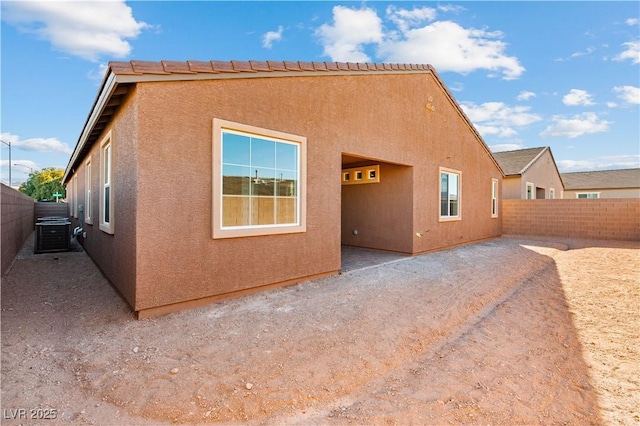 back of house with a patio, a fenced backyard, and stucco siding