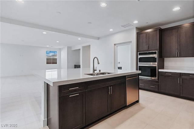 kitchen with visible vents, appliances with stainless steel finishes, light countertops, and a sink