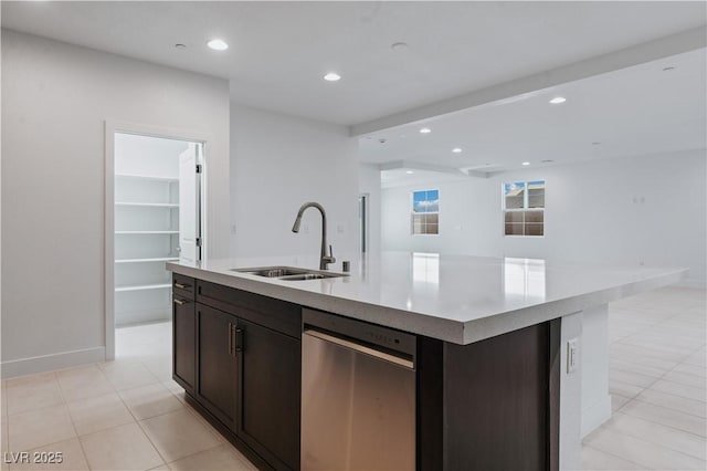 kitchen with open floor plan, a center island with sink, light countertops, recessed lighting, and a sink