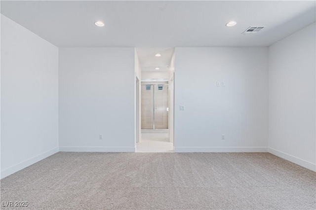 empty room featuring recessed lighting, visible vents, baseboards, and carpet