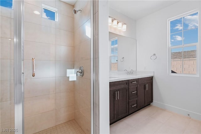 full bath with baseboards, vanity, and a shower stall