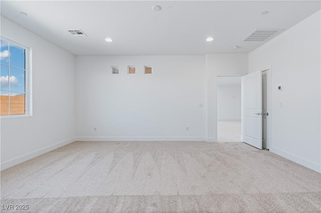 spare room featuring recessed lighting, visible vents, and light colored carpet