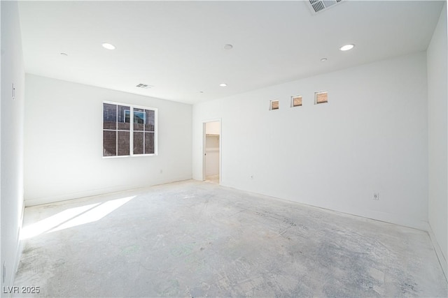 unfurnished room featuring recessed lighting, visible vents, and unfinished concrete flooring