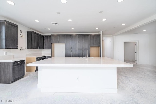 kitchen featuring a spacious island, visible vents, recessed lighting, and light countertops