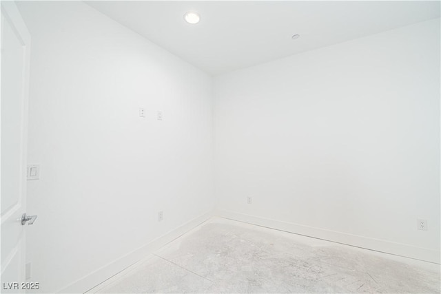 empty room featuring recessed lighting, baseboards, and concrete flooring