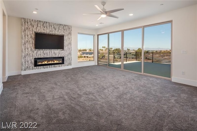 unfurnished living room with recessed lighting, carpet floors, a fireplace, baseboards, and ceiling fan