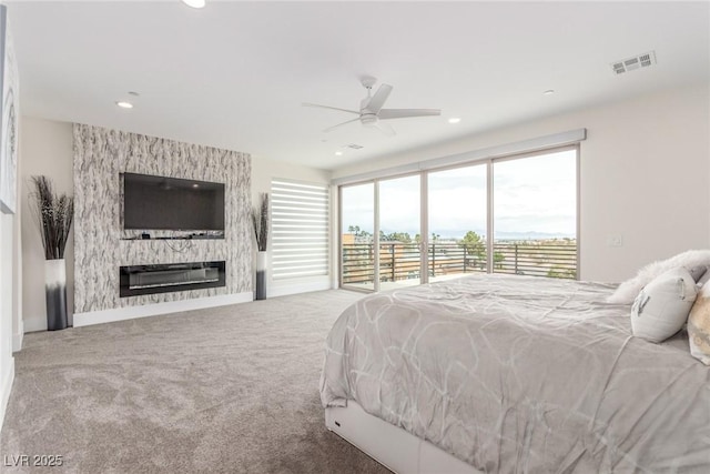 carpeted bedroom featuring a large fireplace, recessed lighting, access to exterior, and visible vents