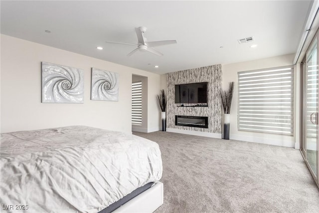 carpeted bedroom with recessed lighting, baseboards, a large fireplace, ceiling fan, and visible vents