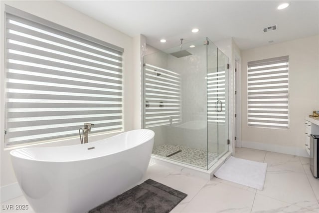 bathroom with visible vents, a soaking tub, marble finish floor, recessed lighting, and a stall shower