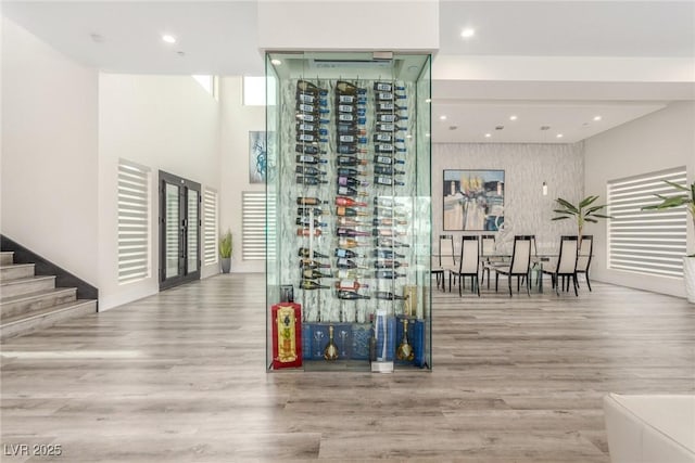wine room featuring a wealth of natural light, wood finished floors, and recessed lighting