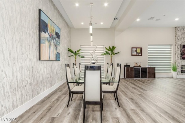 dining room with wallpapered walls, recessed lighting, baseboards, and wood finished floors