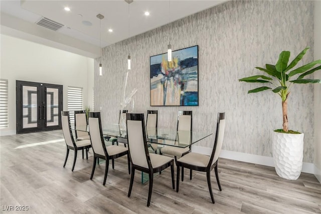 dining area featuring french doors, wood finished floors, baseboards, and visible vents
