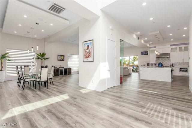 dining space with baseboards, visible vents, recessed lighting, and light wood-type flooring