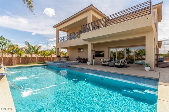 view of pool with a patio, an outdoor living space, fence, and a pool with connected hot tub