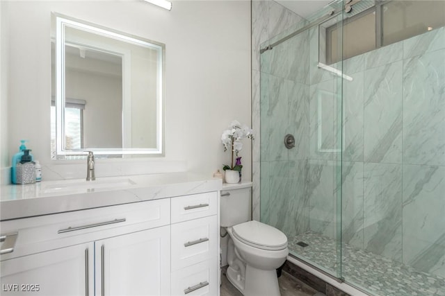bathroom with a marble finish shower, toilet, and vanity