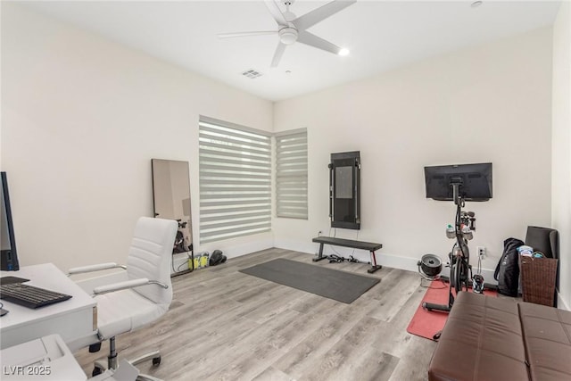 office featuring baseboards, visible vents, wood finished floors, and ceiling fan