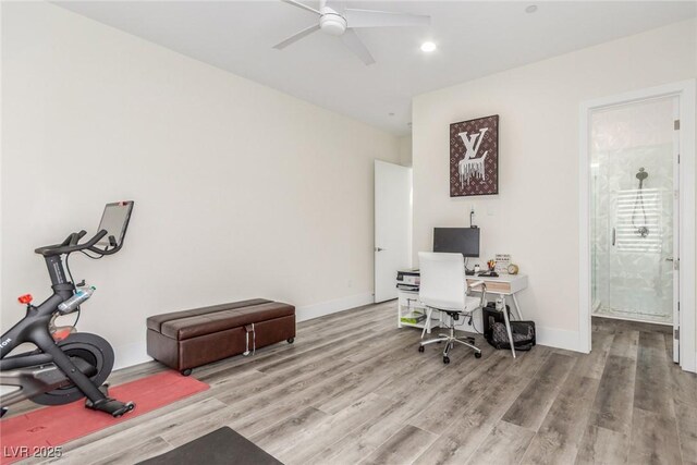 office space featuring baseboards, ceiling fan, and wood finished floors