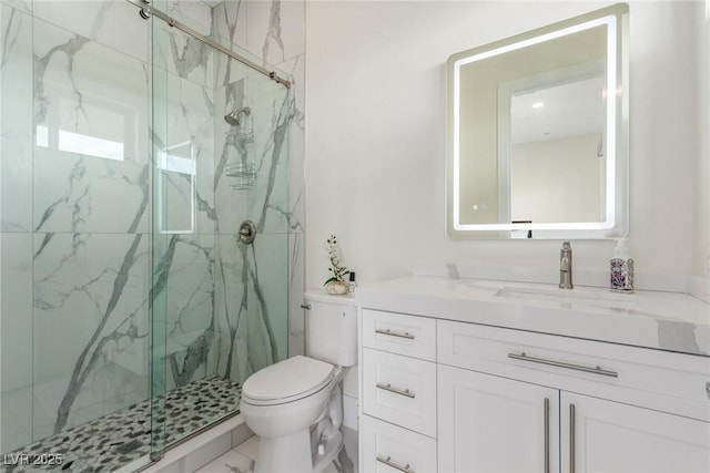 full bathroom with a marble finish shower, toilet, and vanity