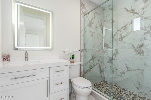 full bathroom featuring toilet, vanity, and a marble finish shower