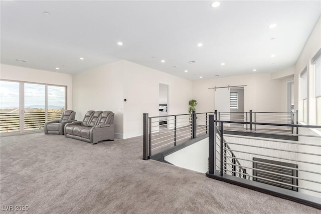 hallway with carpet floors, an upstairs landing, and recessed lighting