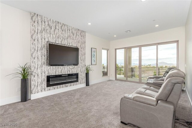 living room with a large fireplace, visible vents, carpet, baseboards, and recessed lighting