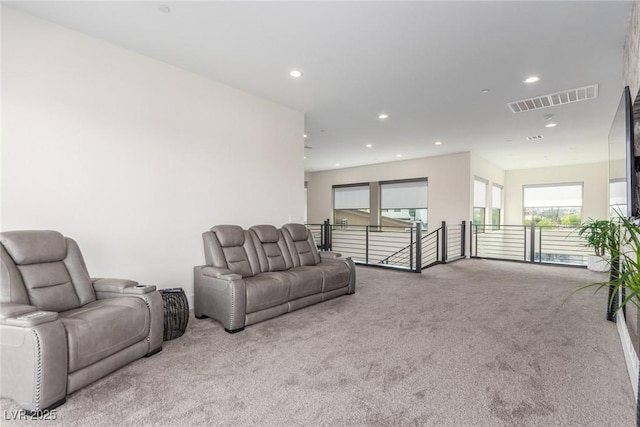 living area featuring visible vents, recessed lighting, and carpet