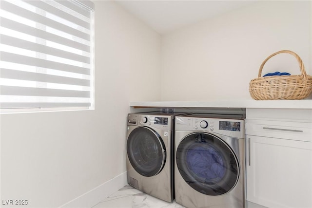 clothes washing area featuring marble finish floor, baseboards, and washer and dryer