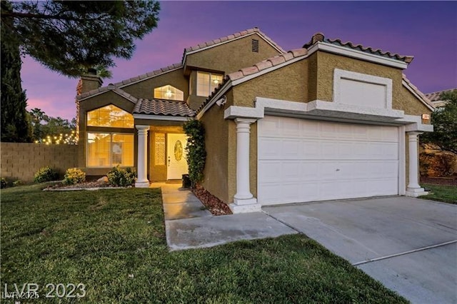 view of front of home with stucco siding, driveway, an attached garage, a chimney, and a tiled roof