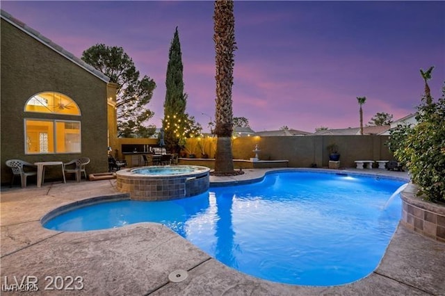 pool at dusk with a patio area, a fenced in pool, an in ground hot tub, and fence