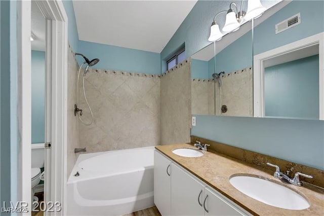 full bathroom featuring double vanity, visible vents, toilet, and a sink