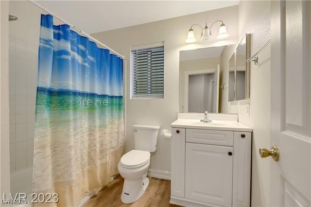 bathroom with toilet, wood finished floors, vanity, and shower / bath combination with curtain