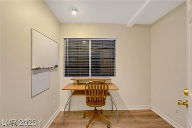 office space featuring baseboards and wood finished floors